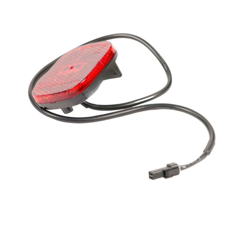 Red bicycle rear light with a black two-pin connector and coiled cable